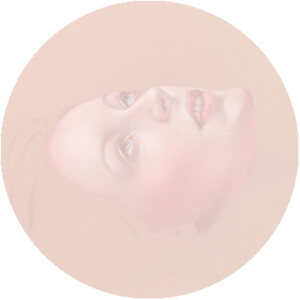Circular framed painting depicting a surreal portrait of a woman with two sets of eyes, one above the other, rendered in a soft, pastel palette.