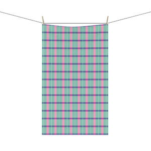 A plaid fabric in shades of green, pink, and blue, displayed at Park West and hanging on a clothesline with two wooden clothespins against a white background.