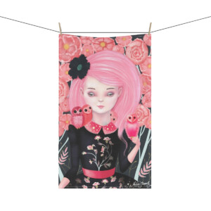 Painting on a hanging towel of a girl with pink hair, surrounded by roses, holding three owls. She wears a black floral dress and has a pink flower accessory in her hair.
