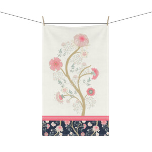 A decorative tapestry featuring a surrealism-inspired tree with pink flowers on a white background, accentuated by a dark floral border, hanging from a line.