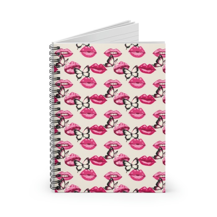 A Lip Service in Pink Spiral Notebook with a whimsical cover featuring alternating rows of pink lips and black and white butterflies on a light pink background.