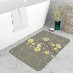 A whimsical bathroom featuring a large white bathtub with a hanging towel, a decorative bath mat with a floral pattern, and a wicker basket next to a vase of dried flowers.